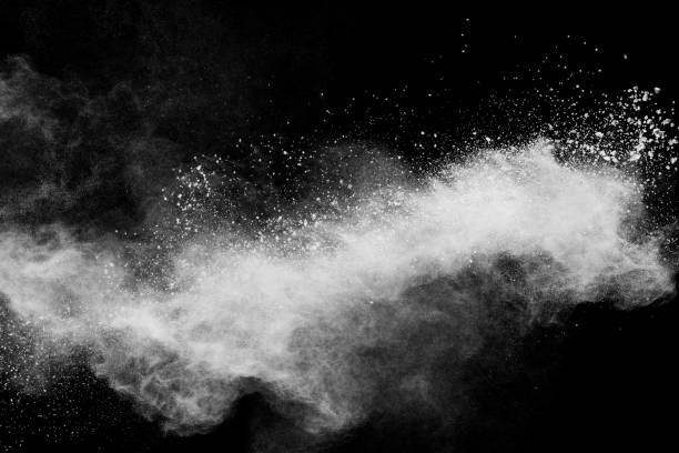 istock Freeze motion of white dust particles splash on black background.White powder explosion clouds. 1204773819