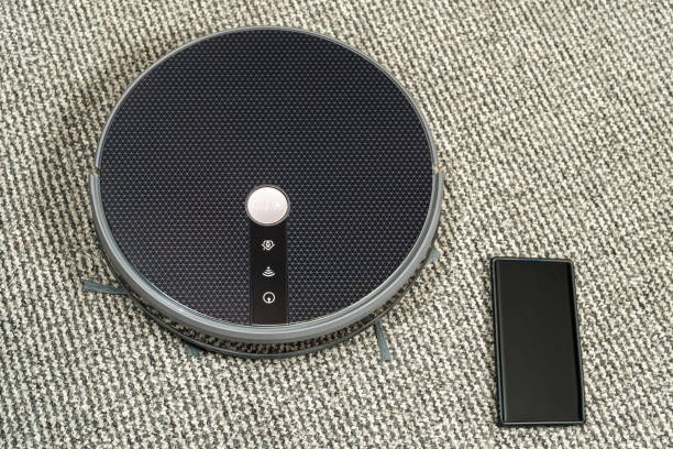 istock phone is near the robot cleaner 1204774121