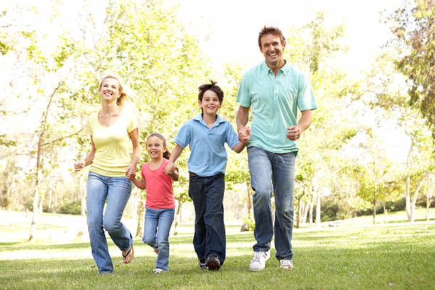 istock Family Running In Park 120477480