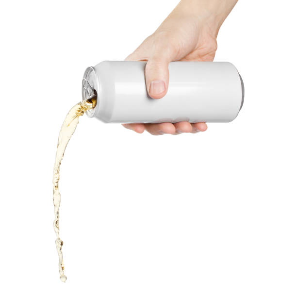 Hand pouring beer or soda on white Hand holding white aluminium can, pouring beer or soda, isolated on white background pouring stock pictures, royalty-free photos & images