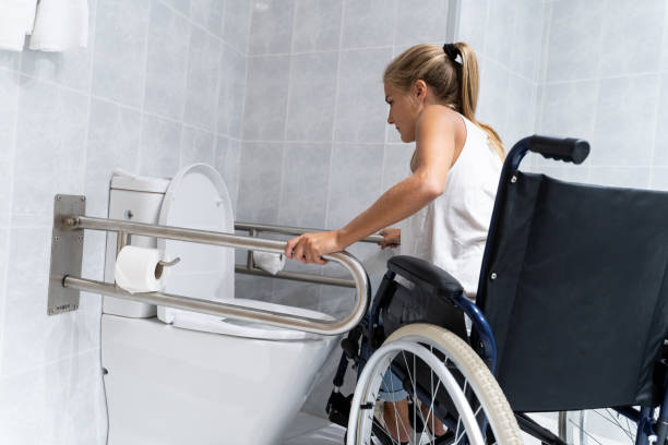 Blonde girl holding on to rails at the toilet trying to get up stock photo