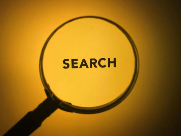 istock Magnifying glass focus on the word search 1204778580