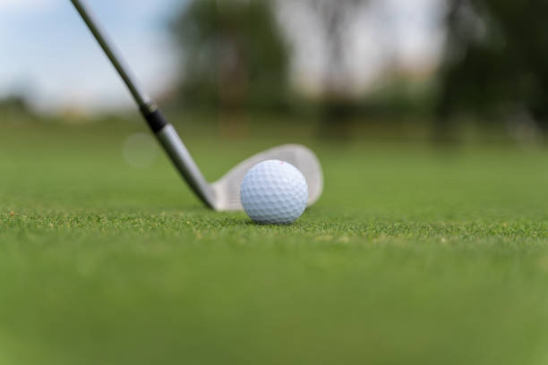 istock Golf ball and golf club on a golf course 1204778622