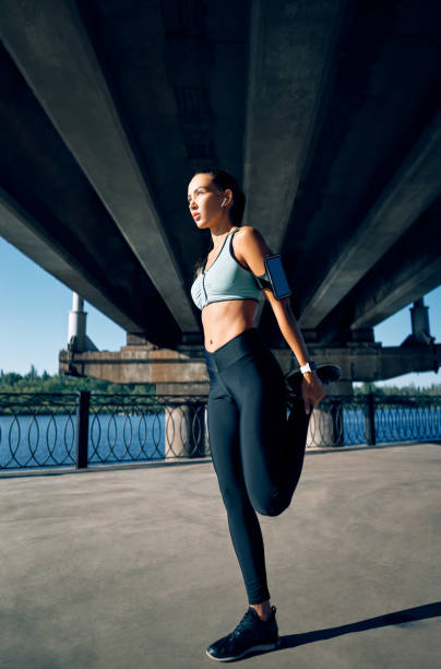 istock Sporty woman runner stretching legs for warming up before exercising 1204779366