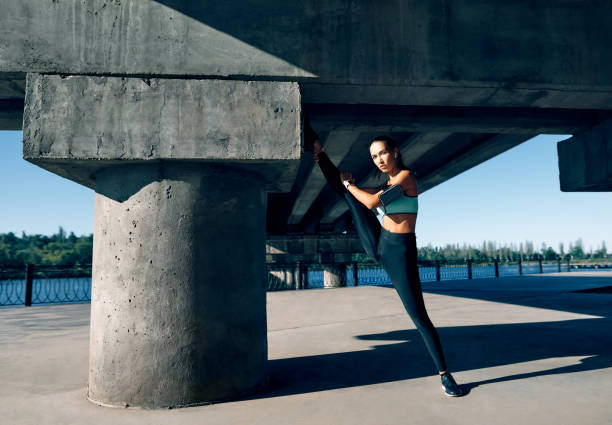 istock Fit woman doing stretching exercises for warming up 1204779384