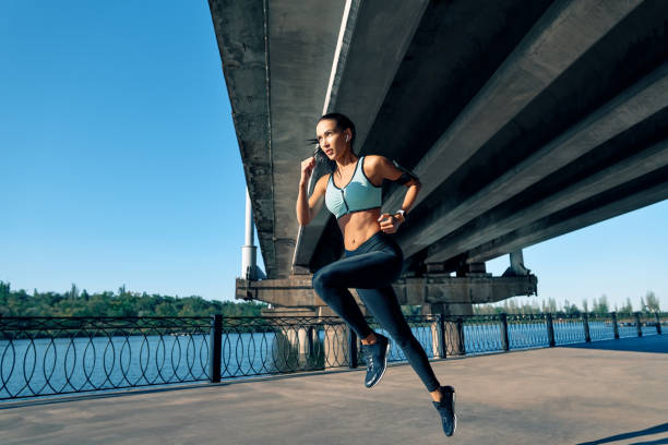 Sporty woman running outdoors by river
