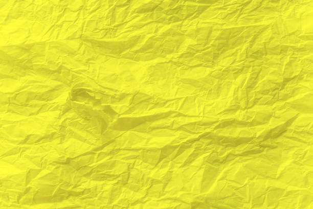 istock Yellow crumpled paper close up texture background 1204779587