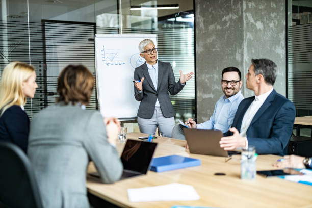 istock Mature CEO talking to her team during a presentation in the office. 1204779885