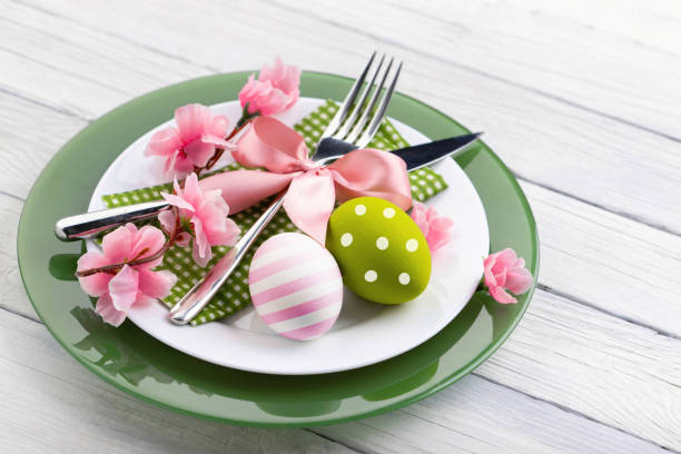 istock Easter composition with colorful eggs and flowers on plate 1204779938
