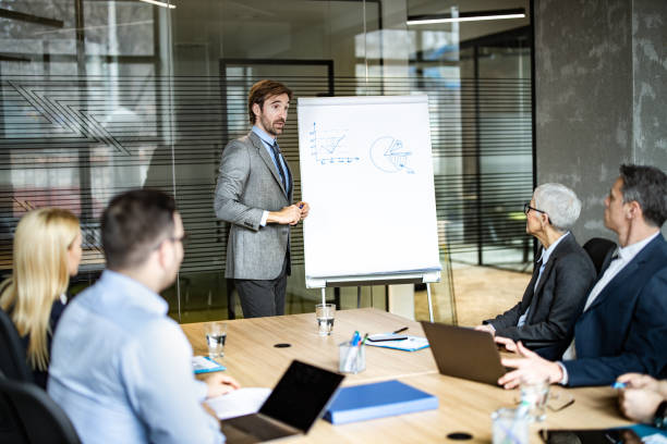 istock Young businessman leading a presentation in the office. 1204780925