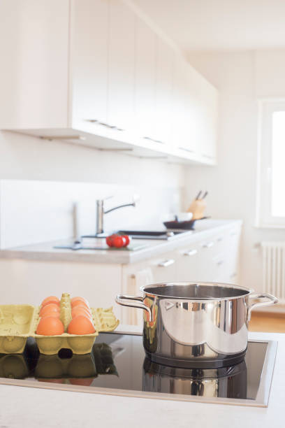 istock White kitchen with pot and eggs in the foreground 1204783589