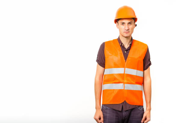 istock smiling worker in protective uniform and protective helmet isolated on white 1204784384