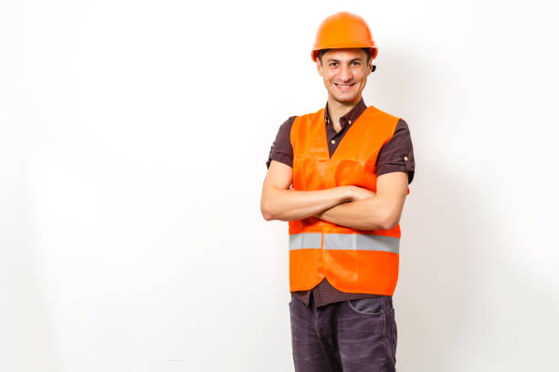 istock smiling worker in protective uniform and protective helmet isolated on white 1204784451