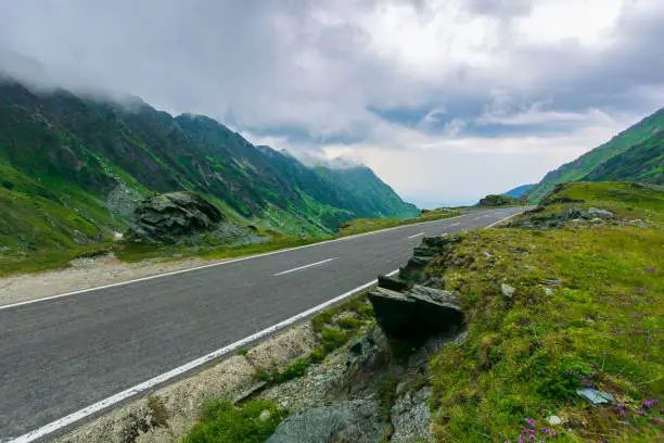Photo of alpine road through mountain valley