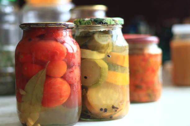 istock jars of pickles tomatoes and cucumbers 1204786805