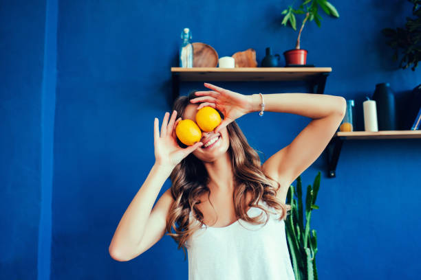 istock beautiful woman with orange 1204790151