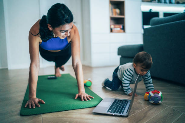istock Mother Exercise With Her Baby At Home 1204790394