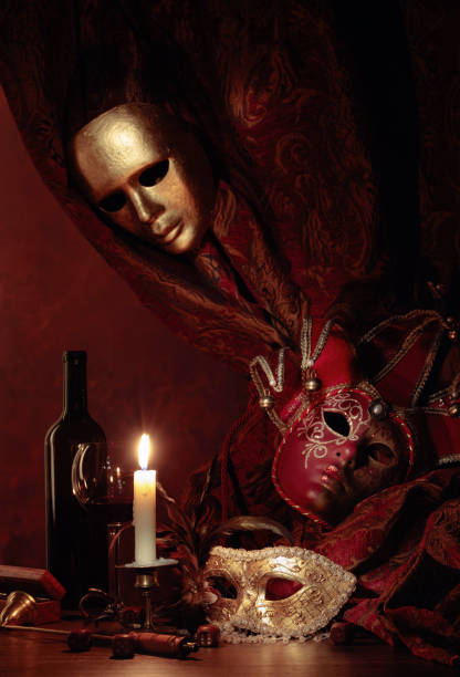 istock Carnival masks and small brass candlestick with burning candle. 1204792051