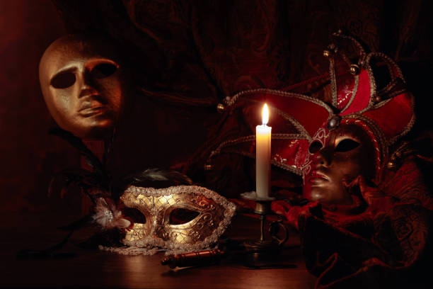 istock Carnival masks and small brass candlestick with burning candle. 1204792056