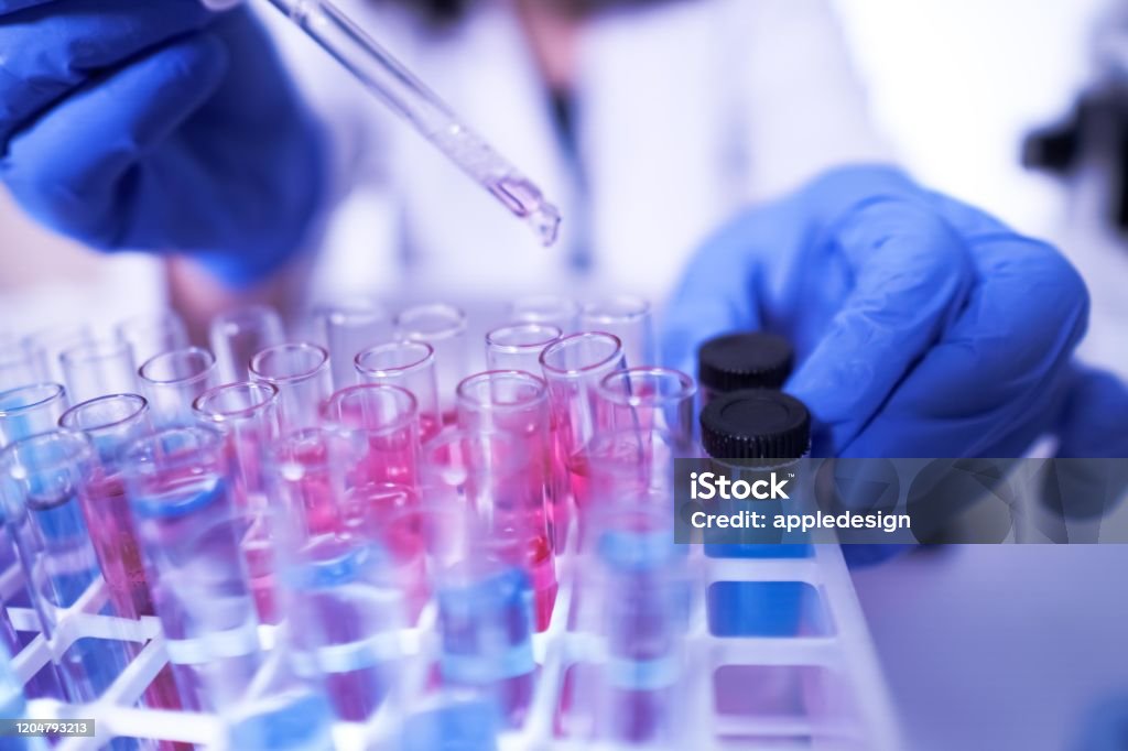 female lab technician doing research with a microscope in the lab. coronavirus Laboratory Stock Photo