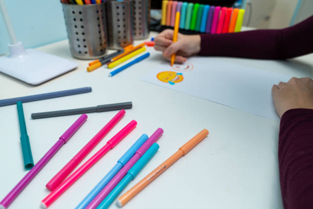 istock Girl drawing emojis 1204793442