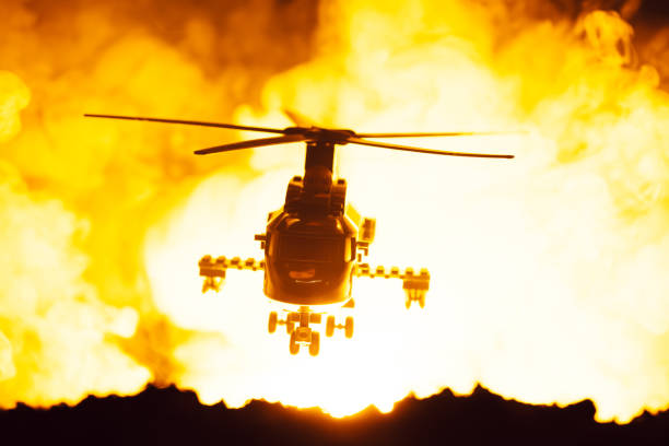 istock Battle scene with toy helicopter and fire at background 1204796826