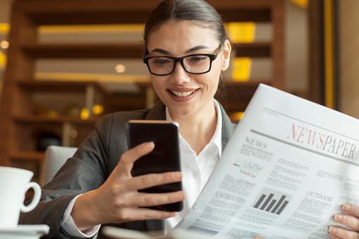 businesswoman reading news at office