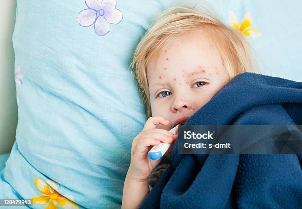 A Sick Girl With Red Spots In Bed With A Thermometer Stock Photo - Download Image Now