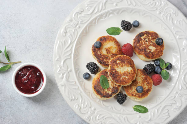 istock Cheesecakes with berries. Cheesecakes served with fresh berries of raspberries, blackberries, blueberry and mint. 1204802068