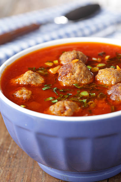 Tomato soup with meatballs in the blue bowl
