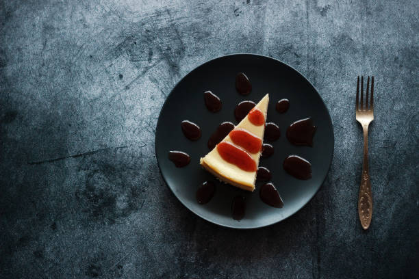 istock Cheesecake on a plate with strawberry sauce 1204808646