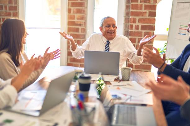 istock Group of business workers smiling happy and confident. Working together with smile on face applauding one of them at the office 1204808849