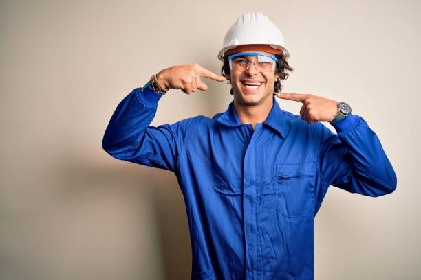 istock Young constructor man wearing uniform and security helmet over isolated white background smiling cheerful showing and pointing with fingers teeth and mouth. Dental health concept. 1204811590