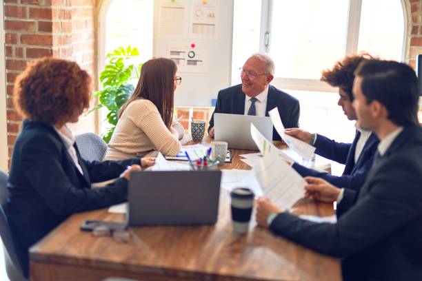 istock Group of business workers smiling happy and confident. Speaking with smile on face working together at the office. 1204811601