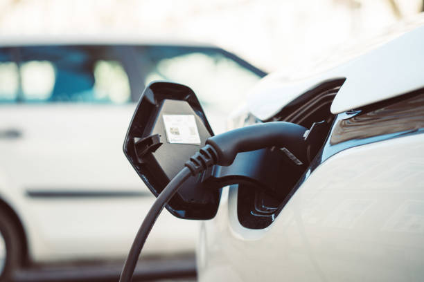 istock Charching an electric car with power cable supply, plugged in 1204811824