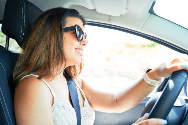 istock Young driver woman driving car 1204815112