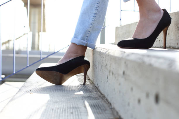 Woman with heels walking down stairs and sprain ankle
