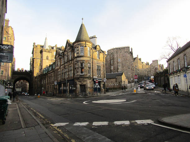 Edinburgh, UK - December 29, 2019: People in victoria street and buildings of different colors on Victoria Street in the Old Town of Edinburgh, victoria street, built between 1829-34 as part of a series of improvements to the Old Town, with the aim of improving access around the city.