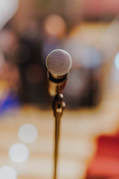 istock Close Up of Microphone Standing at Stage Before Concert 1204821548