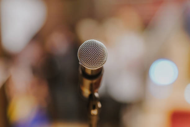 istock Close Up of Microphone Standing at Stage Before Concert 1204821681