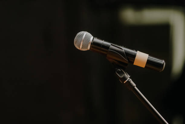 istock Close Up of Microphone Standing at Stage Before Concert 1204821814