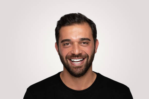 istock Laughing  handsome young man over isolated  gray background 1204825749