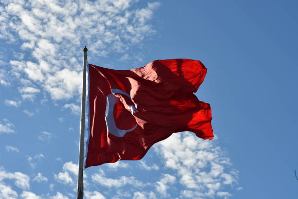 istock Turkish flag waving in the blue sky. 1204825823