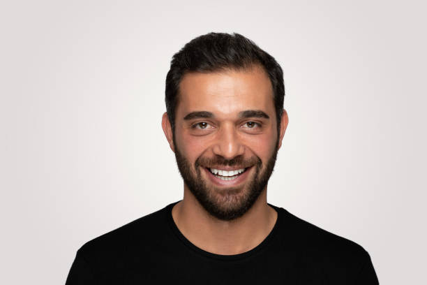 istock Laughing  handsome young man over isolated  gray background 1204826039