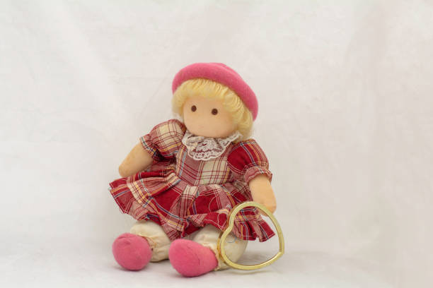 istock Girl doll and  heart on a white background 1204826415