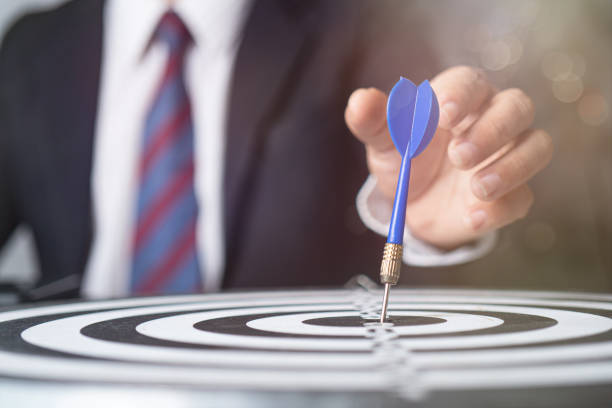 istock target and strategy concept, businessman focus to aim by throwing dart on targeting 1204831373