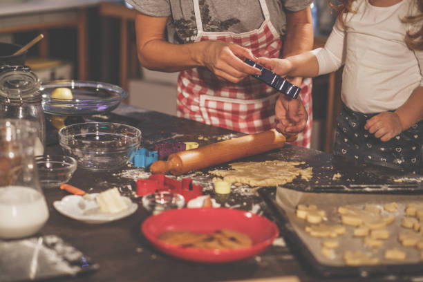 istock Mother and child preparing cookies 1204832419