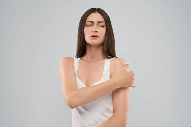 istock Woman showing pain in shoulder. 1204834662