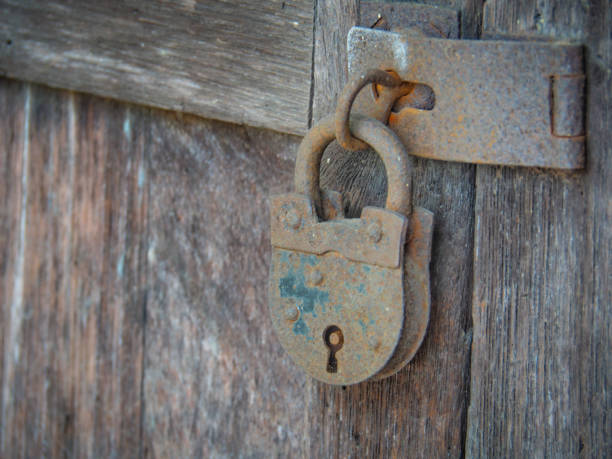 istock A rusty old padlock used to lock old wooden doors 1204839326