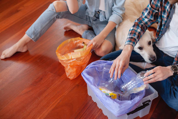 istock charming girl and cute guy share garbage waste 1204839671